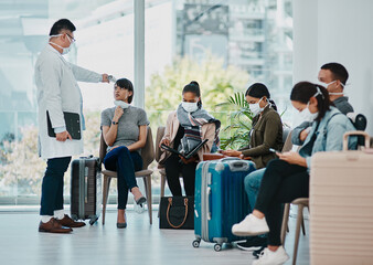 Covid doctor taking temperature of travel passengers in covid masks during tourism in an airport with an infrared thermometer. Medical professional following safe protocol in an epidemic or outbreak