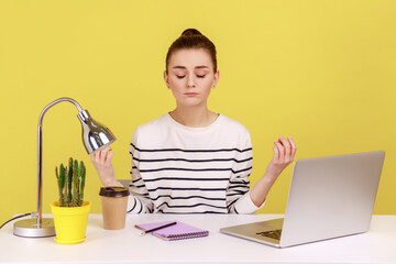 Peaceful mind, break at work. Calm woman sitting at workplace with laptop and raising hands in...