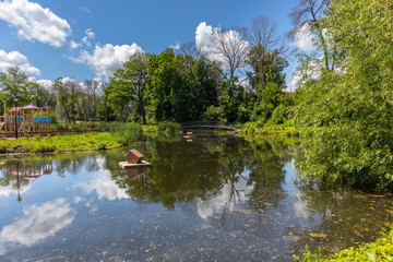pond in the park with a wrought-iron bridge