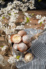 Fototapeta na wymiar Handmade donuts with white spring flowers at the background 