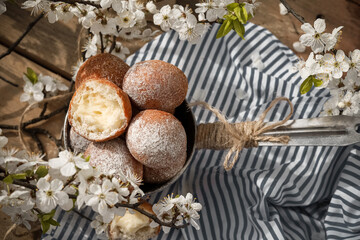 Handmade donuts with white spring flowers at the background 