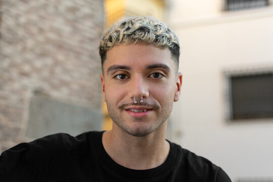 Handsome happy man. Portrait of cheerful young man standing outdoors and smiling at camera. Emotion concept
