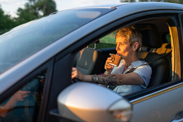 Naklejka premium woman with flask drink alcohol while driving car drunk female driver