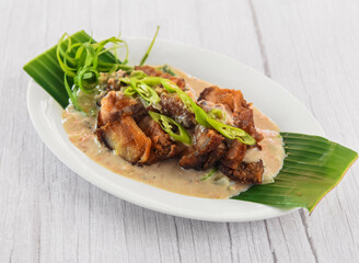 Bicol Express served in dish isolated on grey wooden background side view of fastfood