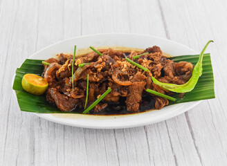 Bistek Tagalog Beef served in dish isolated on grey wooden background side view of fastfood