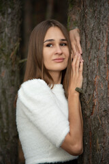 Fototapeta premium portrait of brunette woman in forest in white and black dress