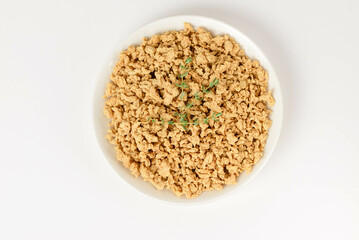 Top view of textured soy protein or soy meat in a white plate isolated on white background