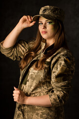 Military woman with camouflage on her face in a cap