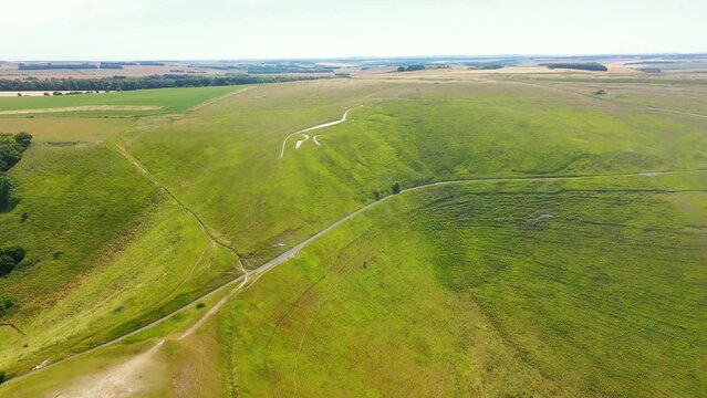 Aerial forward footage of Dragon Hill and famous Uffington White Horse in England.