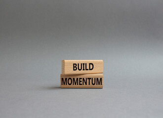 Build momentum symbol. Wooden blocks with words Build momentum. Beautiful grey background. Business and Build momentum concept. Copy space.