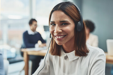 Customer service, IT support or call center agent helping and assisting on a call using a headset. Portrait of a young female sales assistant or secretary smiling while working in a modern office