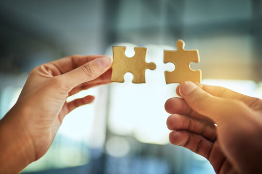 Puzzle, Teamwork And Innovation While People Fit Jigsaw Pieces Together In An Office. Business Solution, Strategy And Success While Plans Come Together. Connection, Partnership And Building Trust