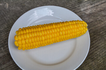 Sweet boiled corn with salt sugar and butter lying.