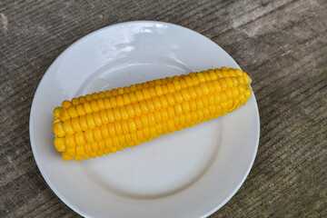 Sweet boiled corn with salt sugar and butter lying.