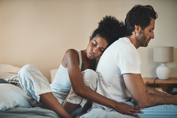 Woman tries to embrace her husband with affection after their fight at home. Unhappy interracial couple with marriage problems forgive each other. Empathy and guilty feelings after the affair. - Powered by Adobe