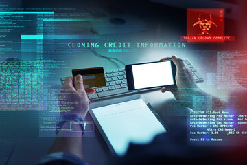 Cyber security, hacking and fraud with a computer hacker holding a credit card and phone while cloning a bank account. Theft, crime and data protection with CGI, special effects or overlay background