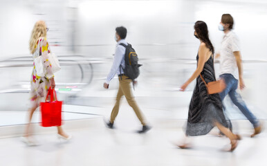 people on moving escalator motion blur