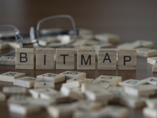 bitmap word or concept represented by wooden letter tiles on a wooden table with glasses and a book
