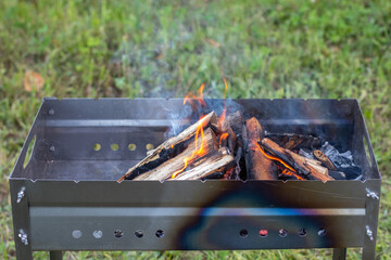 burning logs in the grill