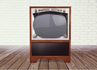 An old retro TV standing in front of the wall in the room. Antique and vintage television images.