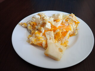 scrabbled eggs with vegetales served on a plate