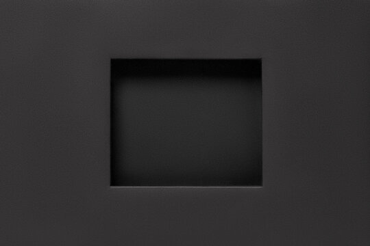 Black paper frame with rectangular recess. Abstract cardboard poster mockup. Blank recessed picture frame texture. Empty mount board background. Minimalism concept. Copy space.