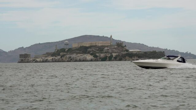 This video shows a speed boat passing by Alcatraz island in slow motion.