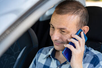 Man talking on the phone inside the car