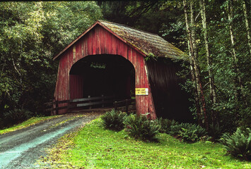 A vintage red covered bridge over the xxxx river near the village of xxx Oregon