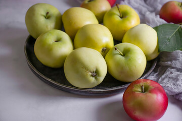 Fresh apples with leaves on a light background