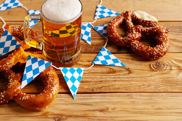 Oktoberfest concept with pretzel and blue simbol flag on wood background - obrazy, fototapety, plakaty