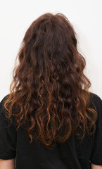 Dry and frizzy natural curly hair that needs hydration. Natural curls before salon treatment. close up.