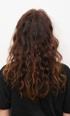 Naklejka premium Dry and frizzy natural curly hair that needs hydration. Natural curls before salon treatment. close up.
