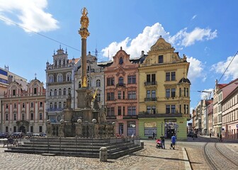 plague column and historical houses on the square in Pilsen