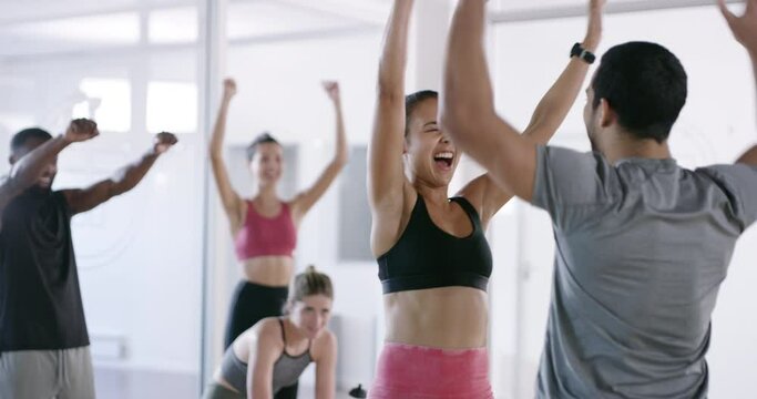 Fit and excited people giving high five during workout, celebrating fitness goal and cheering in support at a gym. Active, happy and sporty friends doing exercise, training and expressing passion