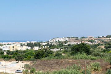 View of the city and the sea. Paphos, Cyprus. Green in the city and clear blue sea.