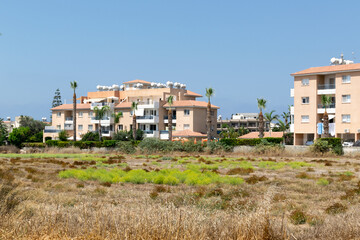 Fototapeta na wymiar Residential buildings in the city of Paphos. Cyprus. Bright houses in the sunshine.