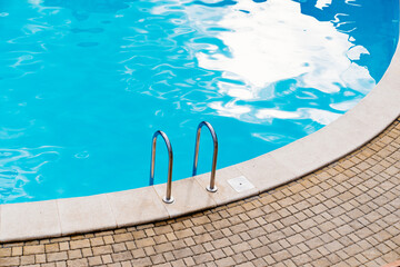 handrails of stairs for descent into the pool. the concept of summer holidays.