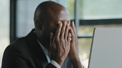 Tired stressful african male adult sad businessman feel tiredness discomfort eyestrain fatigue pain from hard overwhelmed computer work massaging dry irritable eyes exhaustion unwell health concept
