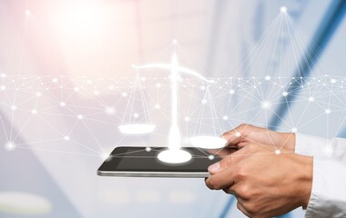 Justice and law concept. Legal advice. Hand hold tablet with digital hologram