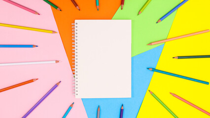 Copy space background with ope notebook and colorful pencils. Flat lay Back to school or art concept