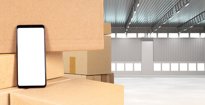 Warehouse with boxes. The phone costs a cardboard box. Phone with white screen. Empty warehouse space.