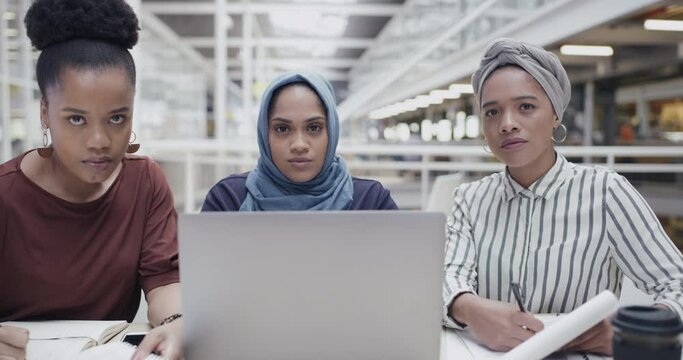Serious, powerful and diverse businesswomen working on activist project for women empowerment and awareness of inequality in the workplace. Face of busy organized multicultural islamic african women
