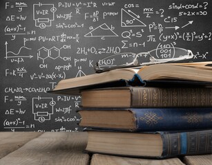 Math geometry formulas on board background and books.