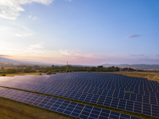 Solar farm system on a field. Green energy renewable resources climate change and clean environment background.