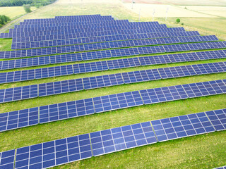Solar panels  farm on a field. Green energy renewable resources and clean environment background.