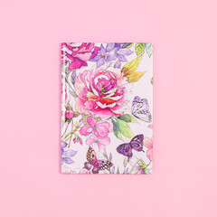 Floral beautiful notebook on pastel pink background. Flat lay