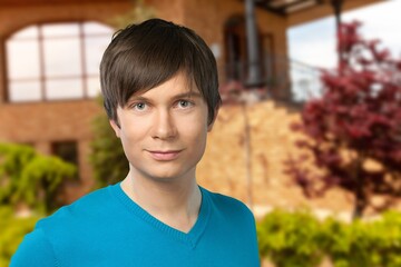 Portrait of young happy man outdoors