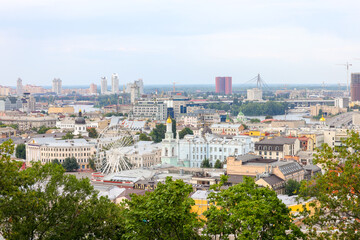 Fototapeta na wymiar beautiful view of summer Kiev. Roofs of Podol and a view of the left bank