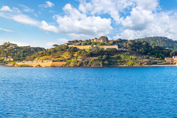 The historic 17th century fortress citadel in the hills above the town of Saint-Tropez, along the Cote d'Azur, French Riviera. Seen from the sea.